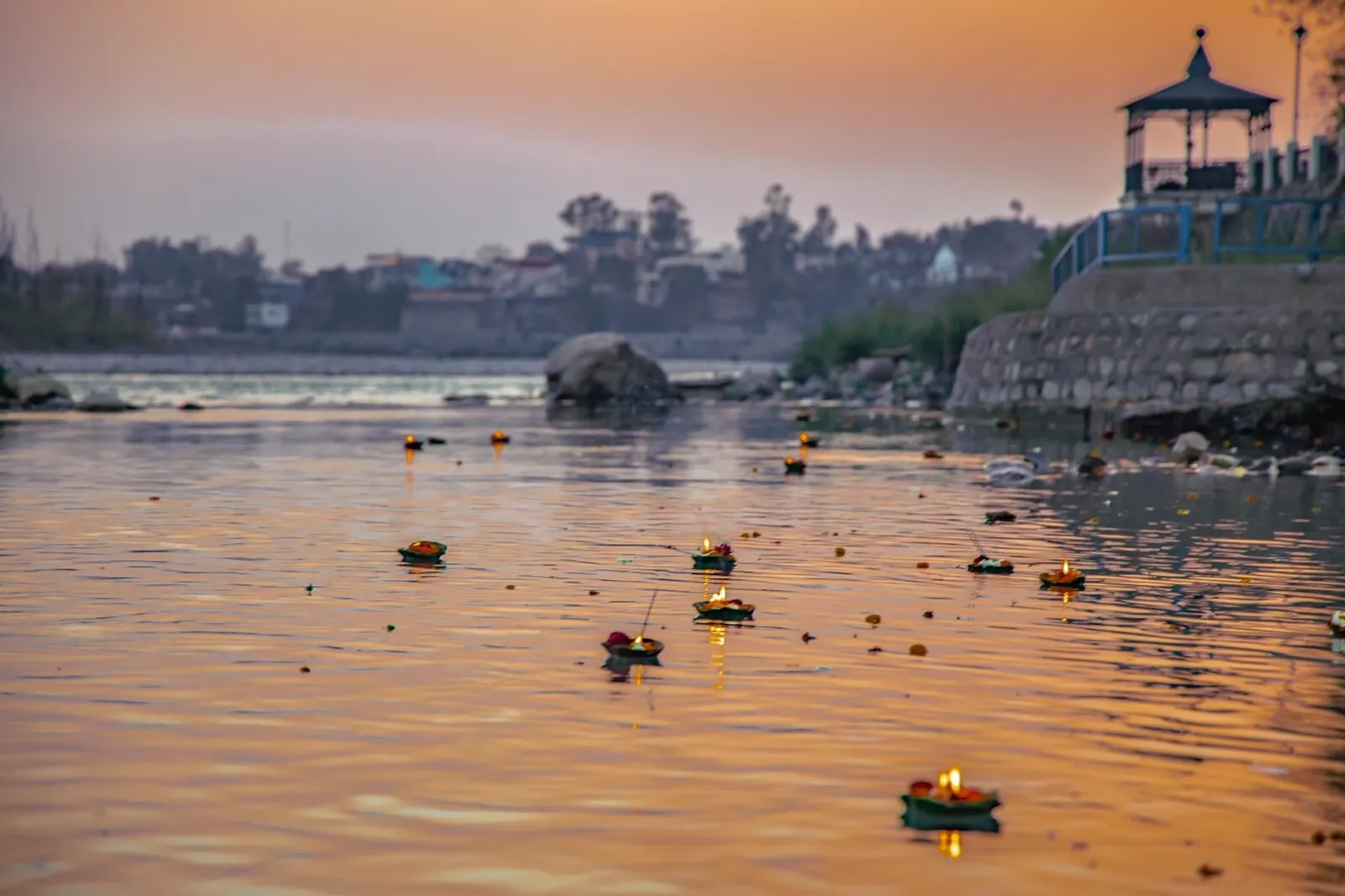 Diyas floating on the Ganges at dusk beside EllBee Ganga View, Rishikesh